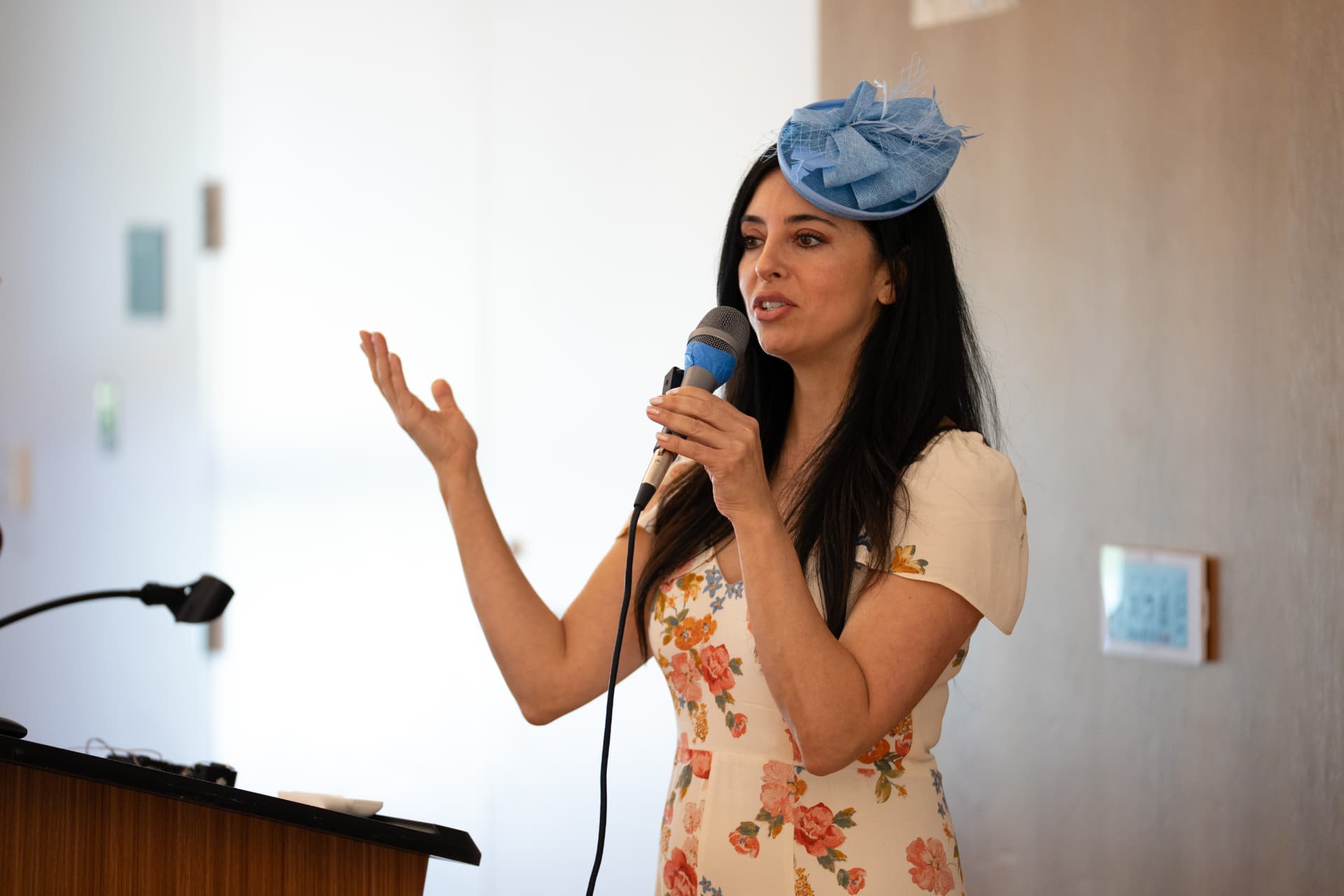 Speaker addressing guests at the podium during the event